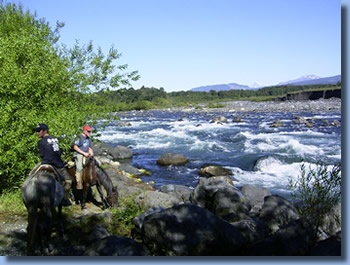 Riders on the banks of Trancurs river on a half day ride in Pucon, Chile